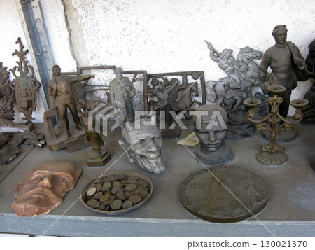 Assorted Metal Sculptures with Coins and Candelabra on Rustic Workshop Shelf 130021370