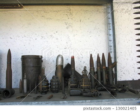 Rustic Military Shelf Showcasing Ammunition, Grenades, and Artillery Shells Rustic Military Shelf Showcasing Ammunition, Grenades, and Artillery Shells 130021405