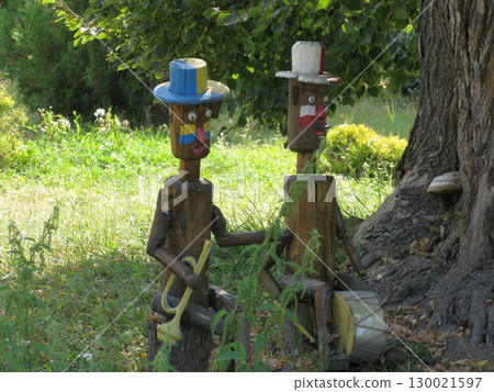 Whimsical Wooden Garden Figures Playing Musical Instruments Near a Tree Whimsical Wooden Garden Figures Playing Musical Instruments Near a Tree 130021597