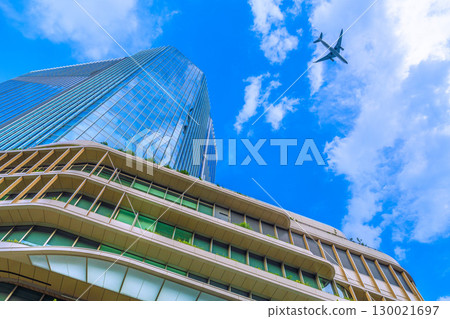 Tokyo cityscape in Japan: Aircraft passing by... Extreme heat, developed clouds over Takanawa Gateway City... = August 21st 130021697