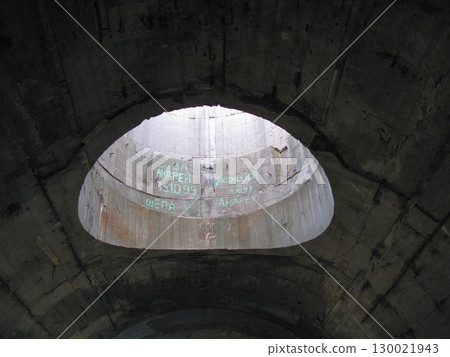 Inside View of a Concrete Tunnel with Graffiti and Light at the End 130021943
