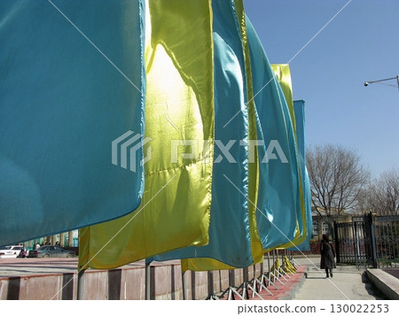 Blue and Yellow Fabric Installation Hanging in an Urban Outdoor Space Under Clear Sky Blue and Yellow Fabric Installation Hanging in an Urban Outdoor Space Under Clear Sky 130022253