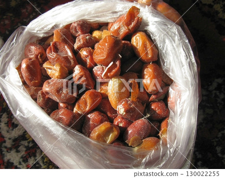 Plastic Bag Filled with Dried Dates on a Patterned Surface in Soft Light 130022255