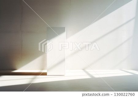 Minimalist scene with light and shadows on monolithic structure in sunlit space 130022760