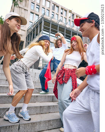 Happy street dance group enjoying movement with laughter and urban style 130023623