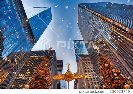 Snowflakes Drift Gently While Looking up at City Skyscrapers Adorned for Christmas 130023749