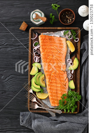 grilled whole salmon fillet on wooden board 130023758