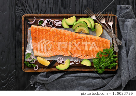 grilled whole salmon fillet on wooden board 130023759