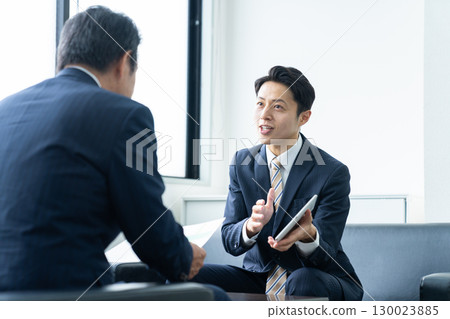 Middle-aged businessman working in the office Middle-aged businessman working in the office 130023885