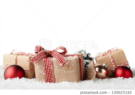 Christmas gift boxes and decor in snow. Isolated on white background 130025192