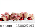 Christmas gift boxes and decor in snow. Isolated on white background 130025193