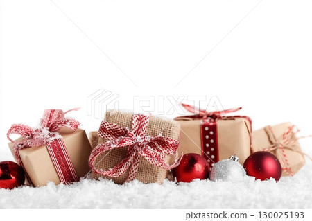 Christmas gift boxes and decor in snow. Isolated on white background 130025193