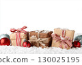 Christmas gift boxes and decor in snow. Isolated on white background 130025195