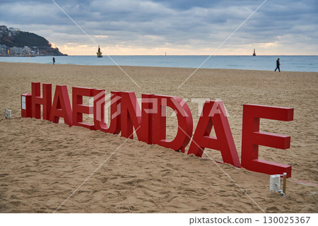 Large red letters Haeundae at Haeundae beach, popular urban sandy beach in downtown Busan, South Korea Large red letters Haeundae at Haeundae beach, popular urban sandy beach in downtown Busan, South Korea 130025367