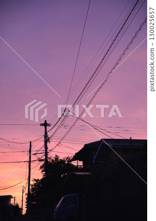 Twilight sky and telephone pole silhouette and sunset 130025657