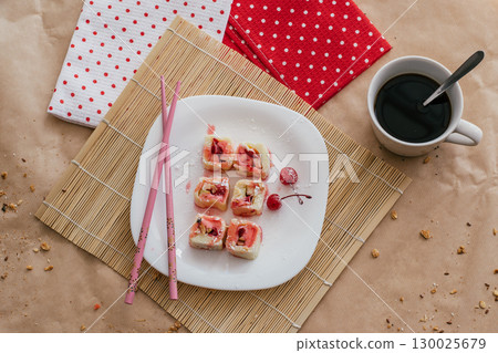 sweet sushi featuring cherries on decorative plate in cozy indoor setting. top view. closeup. sweet sushi featuring cherries on decorative plate in cozy indoor setting. top view. closeup. 130025679