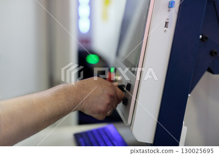 machine operator working with control panel machine operator working with control panel 130025695