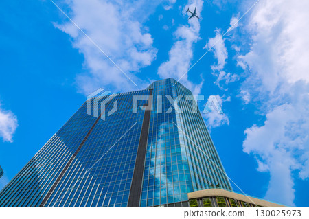 Tokyo cityscape in Japan: Aircraft passing by... Extreme heat, developed clouds over Takanawa Gateway City... = August 21st Tokyo cityscape in Japan: Aircraft passing by... Extreme heat, developed clouds over Takanawa Gateway City... = August 21st 130025973