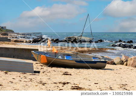 Sea sand beach with boats and blue sky with clouds 130025986