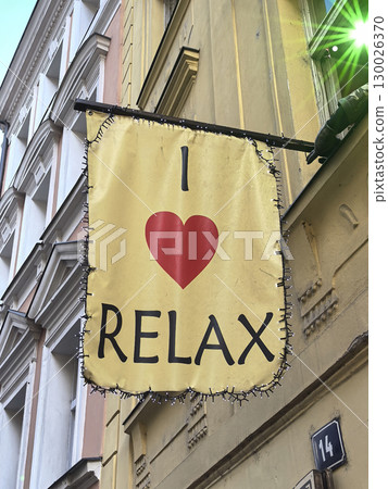 Charming sign encouraging relaxation in a vibrant urban setting Charming sign encouraging relaxation in a vibrant urban setting 130026370