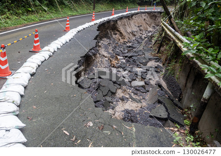 Heavy rain has caused the asphalt road to collapse. Heavy rain has caused the asphalt road to collapse. 130026477