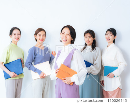 A group of middle-aged women wearing colorful office casual clothes 130026543