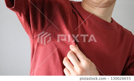 Person with sweaty armpits Person with sweaty armpits 130026655