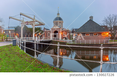 Drawbridge over canal in Leiden Netherlands at dawn 130027226