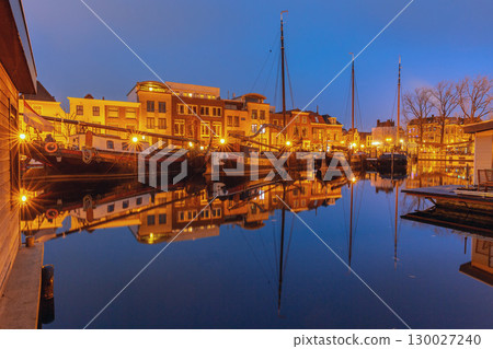 Historic boats in Leiden Netherlands at dawn 130027240