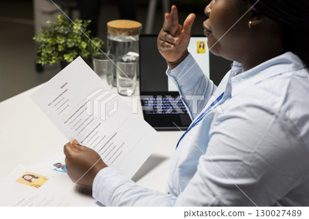 Close up of applicant reviewing monthly perks and medical subscription options, meeting with a recruiter to go over the benefits package for the work contract deal. Reaching an agreement. 130027489