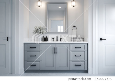 Grey bathroom vanity with white walls, mirror and marble countertop, black hardware. Clean aesthetic background. Home interior room design. Gray cabinet in a bathroom 130027520
