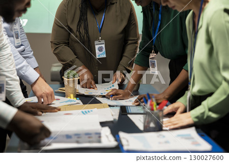 Business consultants team meeting after hours to review diagrams and assess risks, exchanging feedback and collaborating on insights backed by business intel. Forecasting predictions. Business consultants team meeting after hours to review diagrams and assess risks, exchanging feedback and collaborating on insights backed by business intel. Forecasting predictions. 130027600