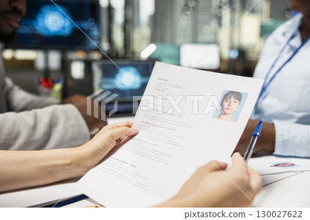 Close up of HR team using artificial intelligence systems to filter resumes, smart automation helping to evaluate applicants and streamline the onboarding process after interviews. Close up of HR team using artificial intelligence systems to filter resumes, smart automation helping to evaluate applicants and streamline the onboarding process after interviews. 130027622