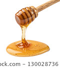 Golden honey pouring smoothly from a wooden dipper isolated on transparent background 130028736