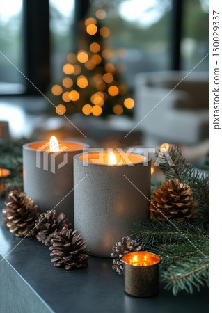 Candlelit table with pine cones and candles. Scene is warm and cozy, perfect for holiday gathering 130029337