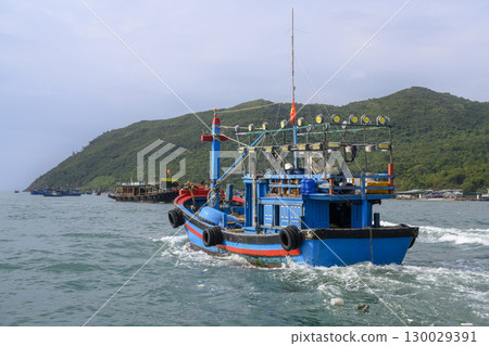 Fishing boat near a mountainous island in the South China Sea near Nha Trang, Vietnam 130029391