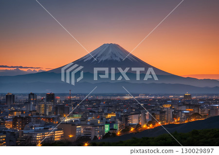 Mount Fuji and the cityscape bathed in the setting sun 130029897