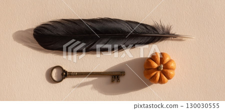 Mystical Flat Lay with Black Feather, Tiny Pumpkin, and Vintage Brass Key Mystical Flat Lay with Black Feather, Tiny Pumpkin, and Vintage Brass Key 130030555