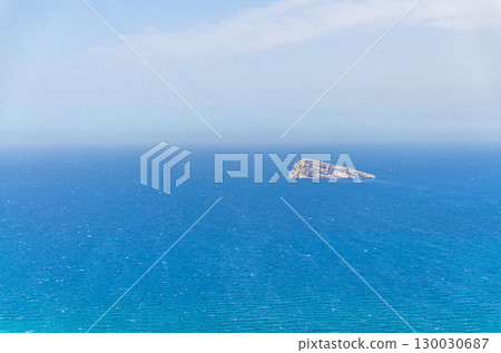 Isla de Benidorm Island rock Peacock Island in Benidorm bay Mediterranean Sea azure water of Costa Blanca in summer day, Valencian Community, Spain 130030687