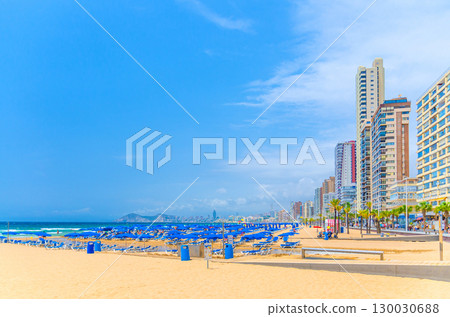 Levante sandy beach, Playa Platja De Llevant, embankment promenade in Old town Benidorm city centre with skyscrapers, hotel buildings on Costa Blanca coast Mediterranean Sea in summer day, Spain Levante sandy beach, Playa Platja De Llevant, embankment promenade in Old town Benidorm city centre with skyscrapers, hotel buildings on Costa Blanca coast Mediterranean Sea in summer day, Spain 130030688