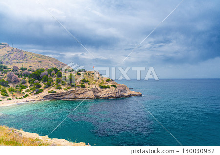 Cala Almadraba Cove beach in Benidorm bay Mediterranean Sea azure turquoise water, Costa Blanca coastline coast in Serra Gelada natural park in summer day, Valencian Community, Spain Cala Almadraba Cove beach in Benidorm bay Mediterranean Sea azure turquoise water, Costa Blanca coastline coast in Serra Gelada natural park in summer day, Valencian Community, Spain 130030932