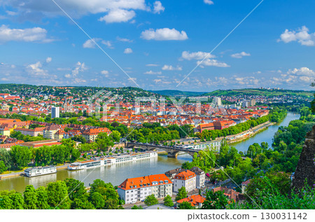 Aerial panoramic view of Wurzburg city historical center with Ludwig Bridge, Main river with touristic ships and green hills background on horizon, Lower Franconia region, Bavaria state, Germany Aerial panoramic view of Wurzburg city historical center with Ludwig Bridge, Main river with touristic ships and green hills background on horizon, Lower Franconia region, Bavaria state, Germany 130031142