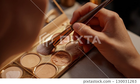 First-Person View of Contour Application with Makeup Palette and Brush 130031263