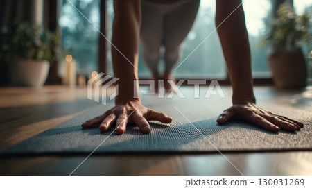 First-Person View of Hands in Yoga Pose on Mat with Natural Lighting 130031269