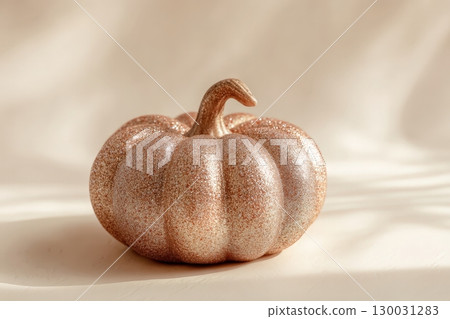 Glitter-Covered Decorative Pumpkin on Cream Background for E-commerce Display 130031283