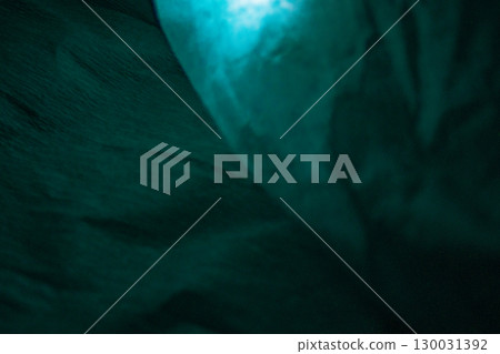 Abstract teal paper surface with folds, wrinkles and shadows.Texture for art projects. Abstract teal paper surface with folds, wrinkles and shadows.Texture for art projects. 130031392