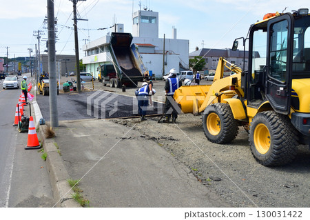 Sidewalk paving work carried out by transporting asphalt with a wheel loader Sidewalk paving work carried out by transporting asphalt with a wheel loader 130031422