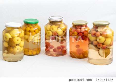 Canned compote in jars of various fruits and berries. Food 130031486
