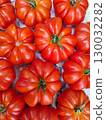 Fresh, ripe red tomatoes arranged in a vibrant display, showcasing their unique shapes and textures, perfect for culinary and agricultural themes 130032282