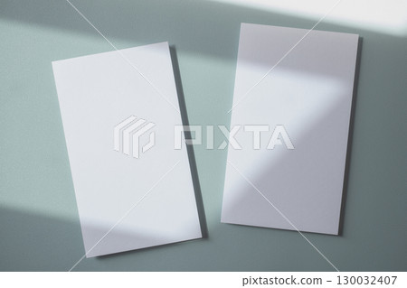 Empty white blank greeting or invitation card on blue background. Mock up presentation. 130032407